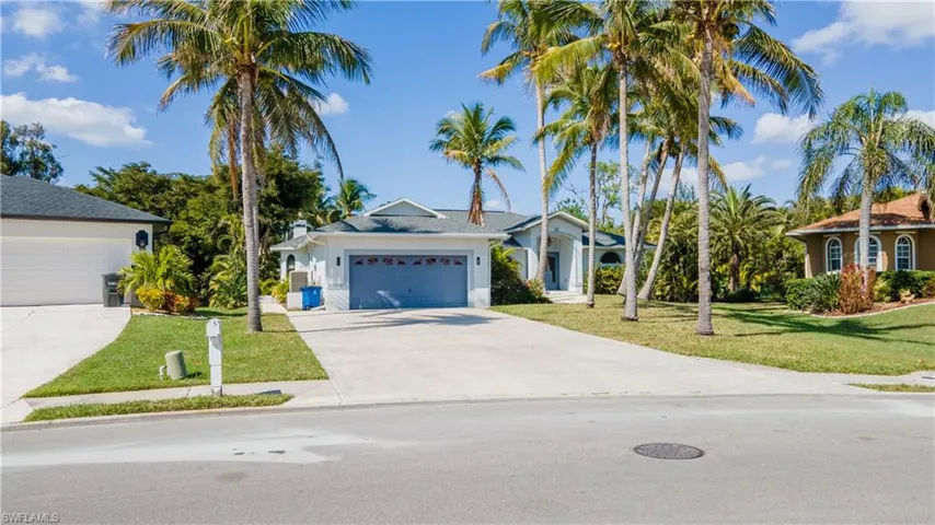 View of front of home featuring a garage and a front lawn