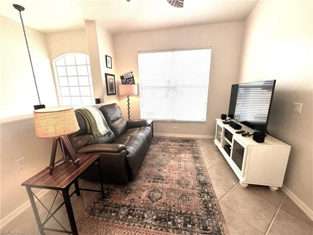 Den with tile flooring