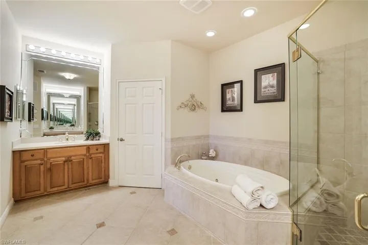 Large Primary bathroom with double vanities, soaking tub, walk-in shower and private water closet.