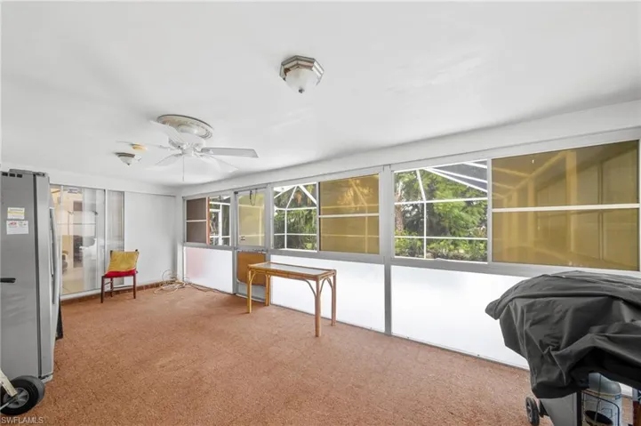 Carpeted office with a ceiling fan