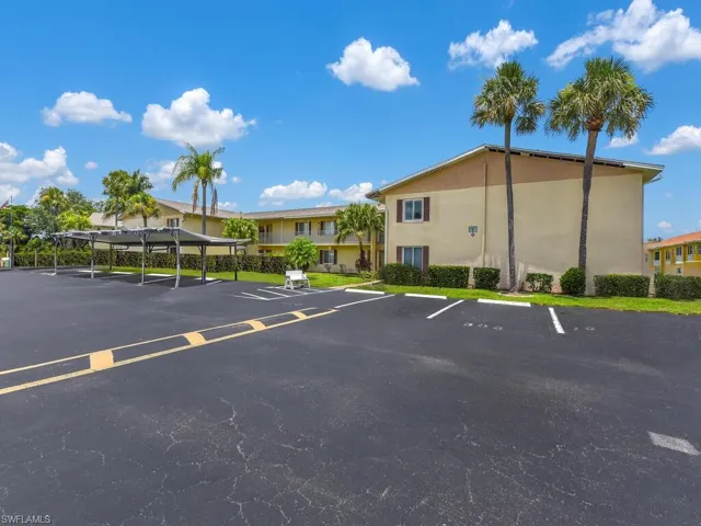 View of parking with a carport