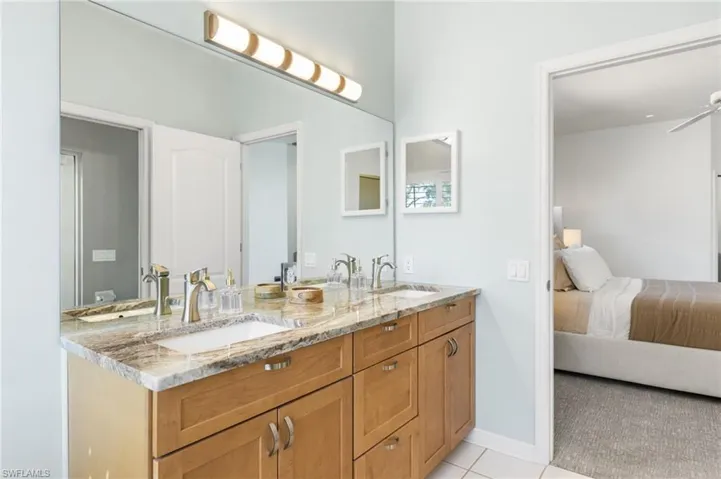 Your primary ensuite bath has access to your lanai and pool area.