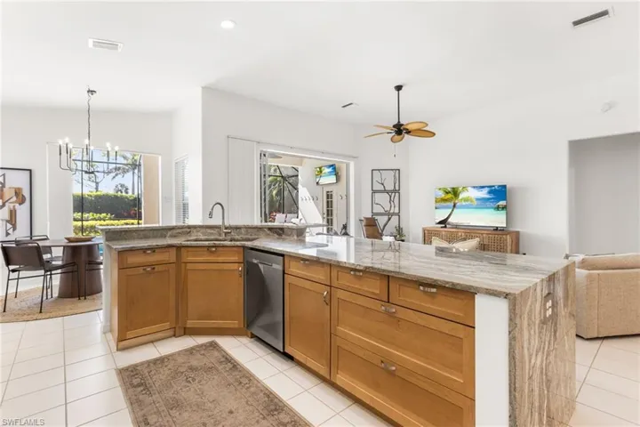 The spacoious living area has volume ceilings. Your dining and living area have access to your lanai and pool area.