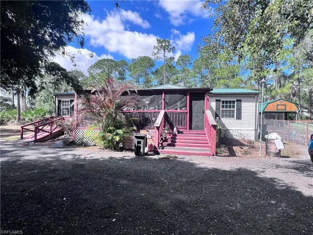 View of front of house featuring a wooden deck