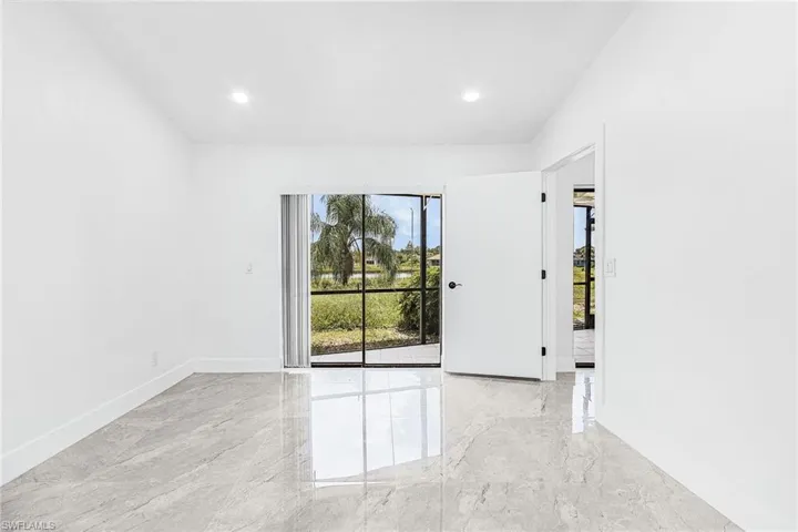 Dining room with sliding glass door leading to screened lanai.