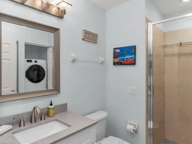 Bathroom featuring vanity and a shower stall