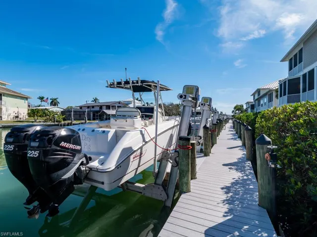 Dock featuring boat lift and a water view