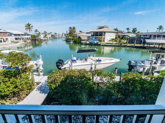 Dock with a water view, a residential view, and boat lift
