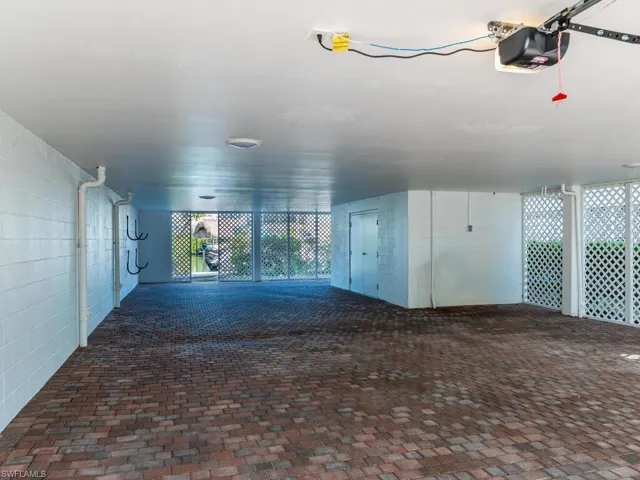 Unfurnished room featuring brick floors