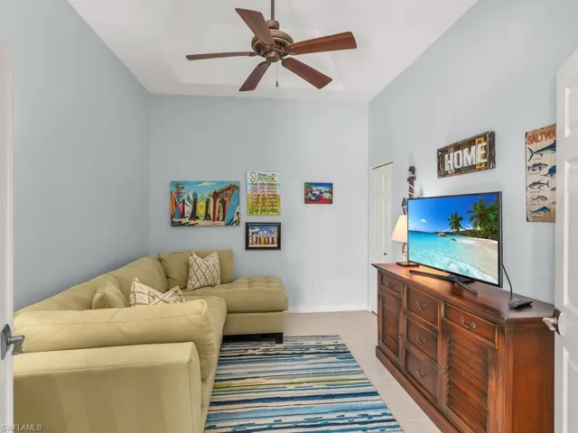 Living area with tile patterned flooring and a ceiling fan