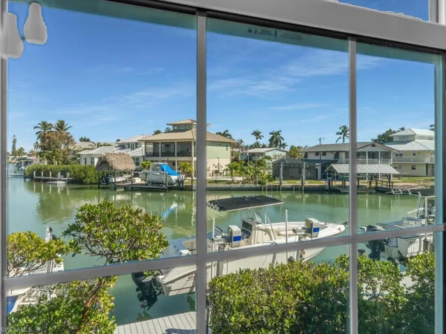 Water view with nearby suburban area and a dock