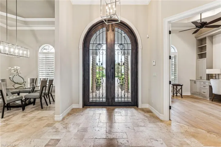 Foyer with french doors, crown molding, and plenty of natural light