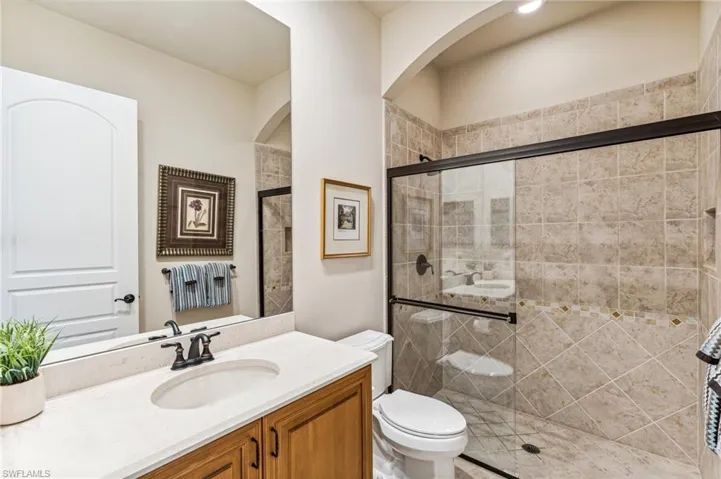 Bathroom with walk in shower, vanity, and toilet