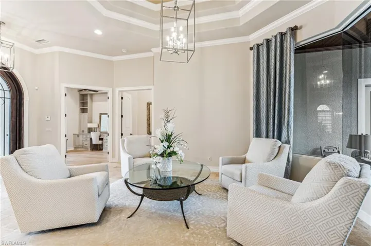 Living room with a towering ceiling and crown molding