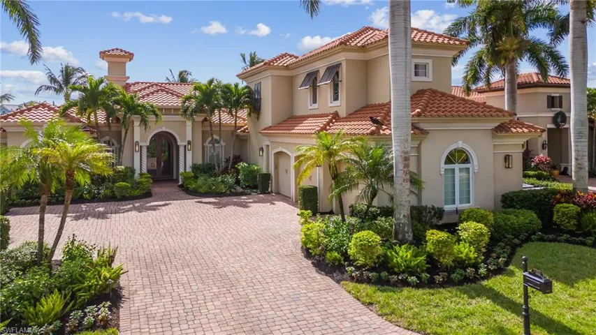 Mediterranean / spanish home with a garage and a front yard