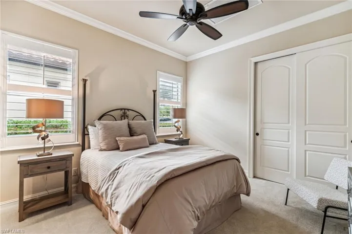 Bedroom featuring ceiling fan, a closet, and crown molding