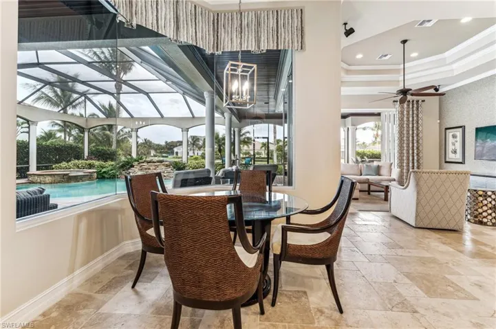 Dining space featuring ceiling fan and crown molding