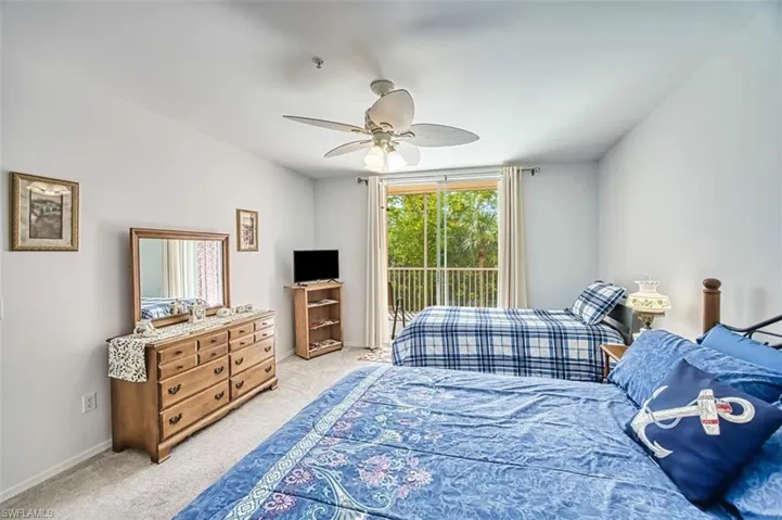 Bedroom featuring light carpet, baseboards, access to outside, and ceiling fan