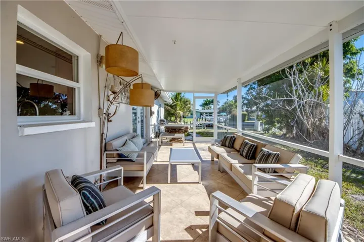 Sunroom / solarium featuring an outdoor hangout area, floor to ceiling windows, plenty of natural light, and tile patterned flooring