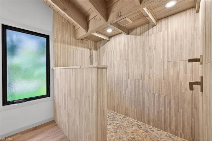 Primary Bathroom featuring a walk in shower and light wood-style flooring