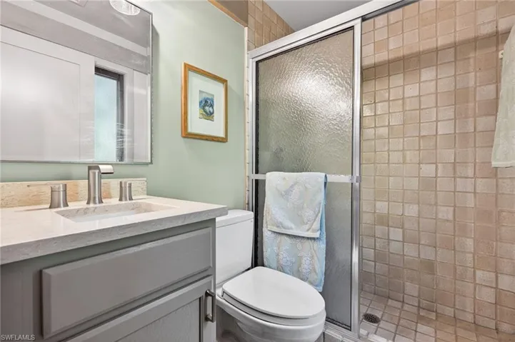 Full bathroom with a shower stall and vanity