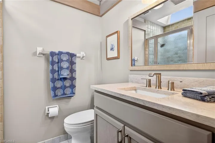 Full bath with vanity and a stall shower