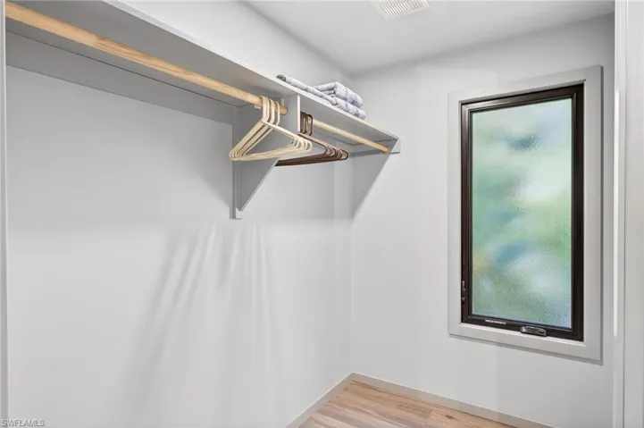 Walk in closet featuring light wood finished floors