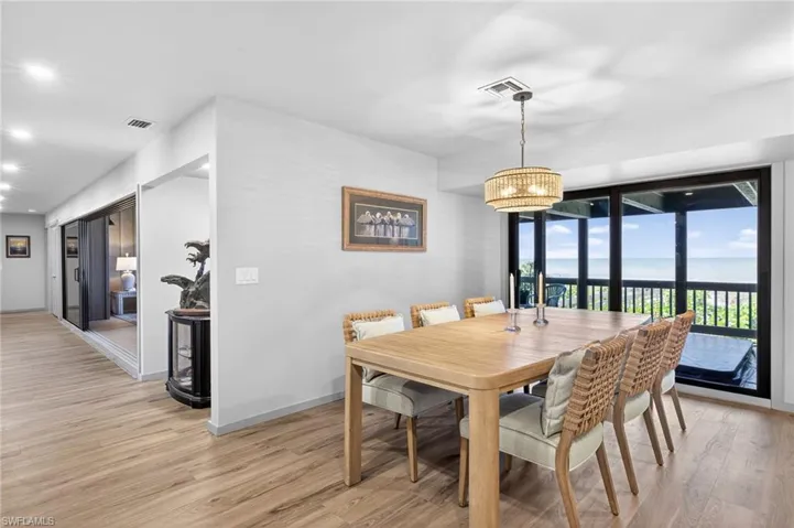 Dining area with light wood-style floors and recessed lighting