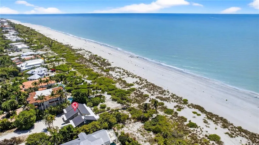 Aerial view of residential area with waterfront with a beach