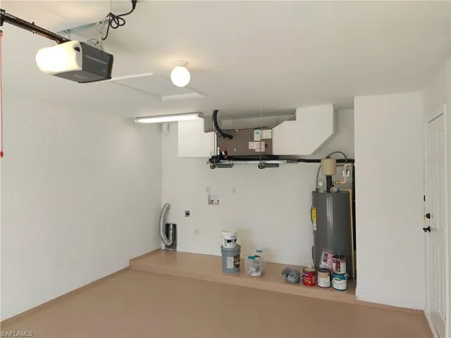 Garage with a garage door opener and water heater