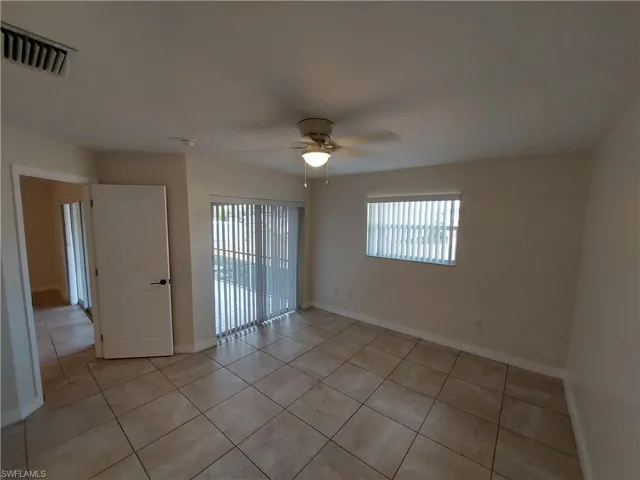 Spare room featuring a ceiling fan and light tile patterned flooring
