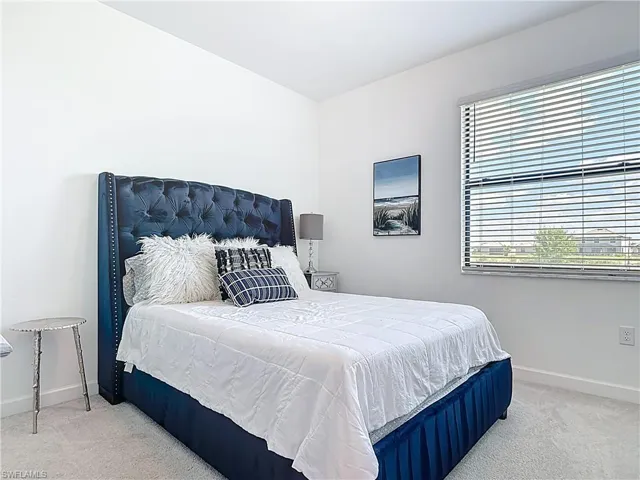 Bedroom with baseboards and carpet flooring