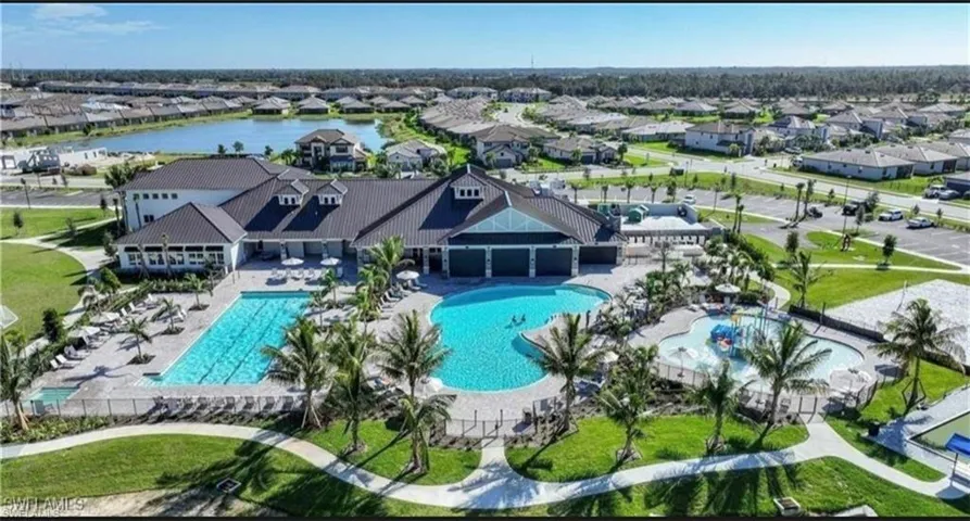 Community pool featuring a residential view and a water view