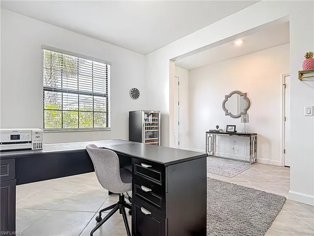 Office area with light tile patterned floors and baseboards