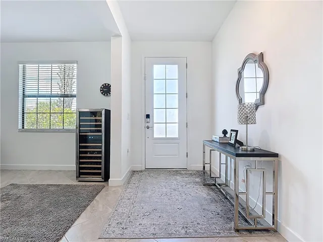 Doorway with wine cooler and baseboards