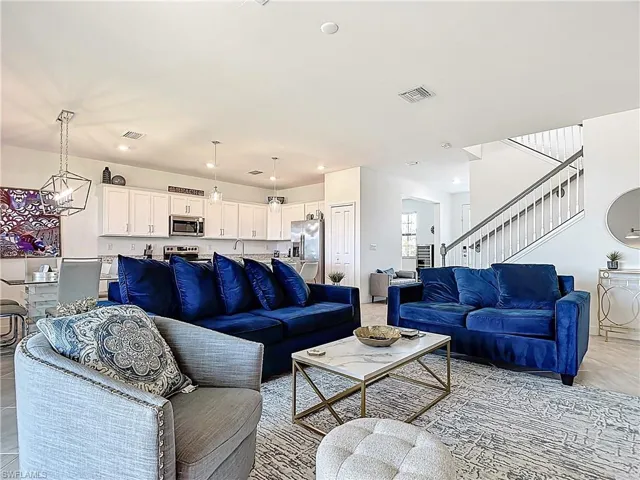 Living room with visible vents, recessed lighting, and stairway