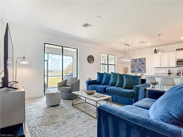 Living area featuring visible vents, baseboards, a chandelier, recessed lighting, and light tile patterned flooring