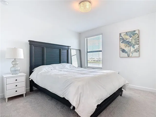 Bedroom with carpet floors and baseboards