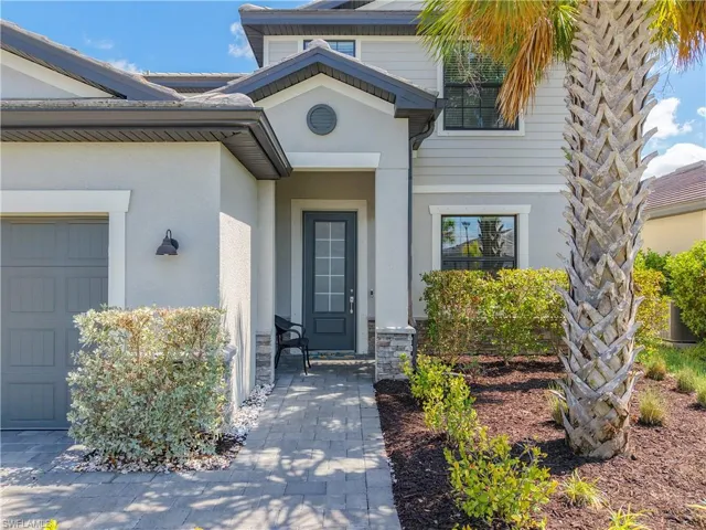 Doorway to property with stucco siding and an attached garage