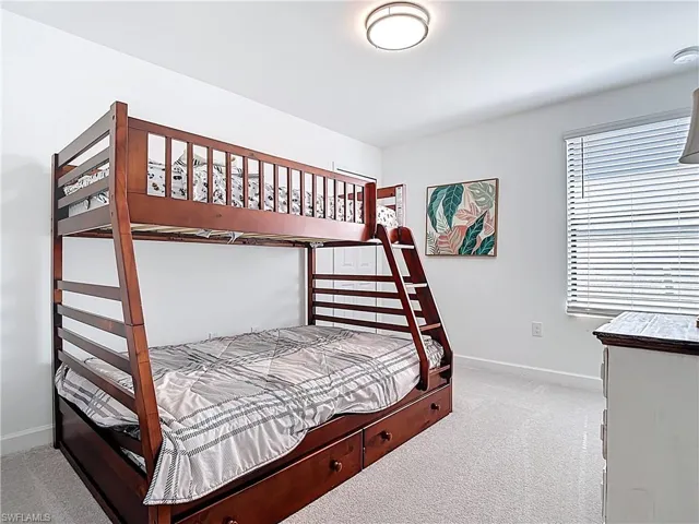 Carpeted bedroom with baseboards