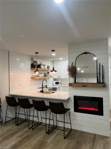 Kitchen island with a white countertop and a matte black faucet