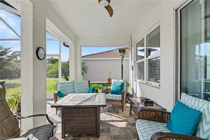 Sunroom with outdoor furniture, a patio, and a ceiling fan