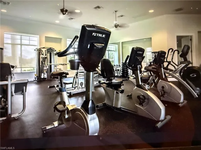 Exercise room featuring recessed lighting and a ceiling fan