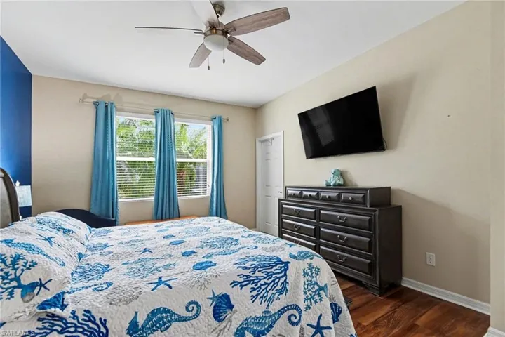 Bedroom featuring dark wood-style flooring and a ceiling fan
