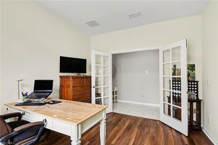 Home office featuring french doors and dark wood finished floors