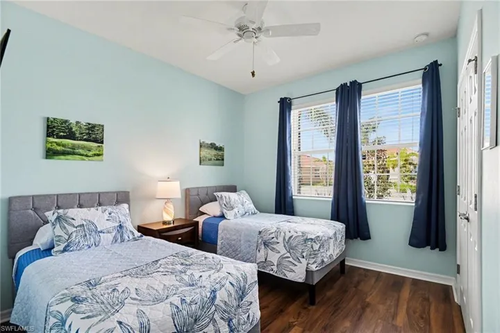 Bedroom featuring dark wood-type flooring and a ceiling fan