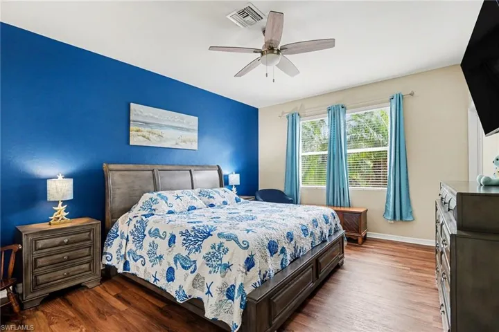Bedroom with dark wood finished floors and ceiling fan