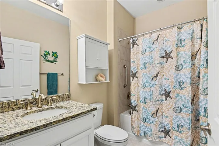 Bathroom featuring vanity and shower / tub combo