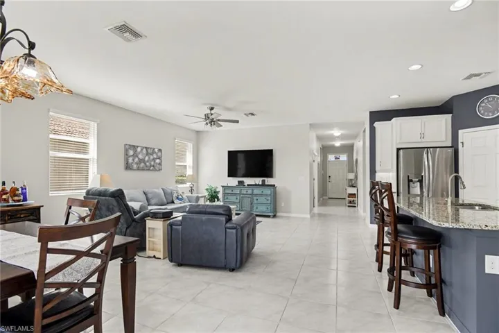 Living room featuring recessed lighting, a ceiling fan, and light tile patterned floors