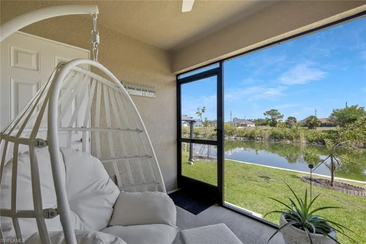 Sunroom / solarium featuring a water view